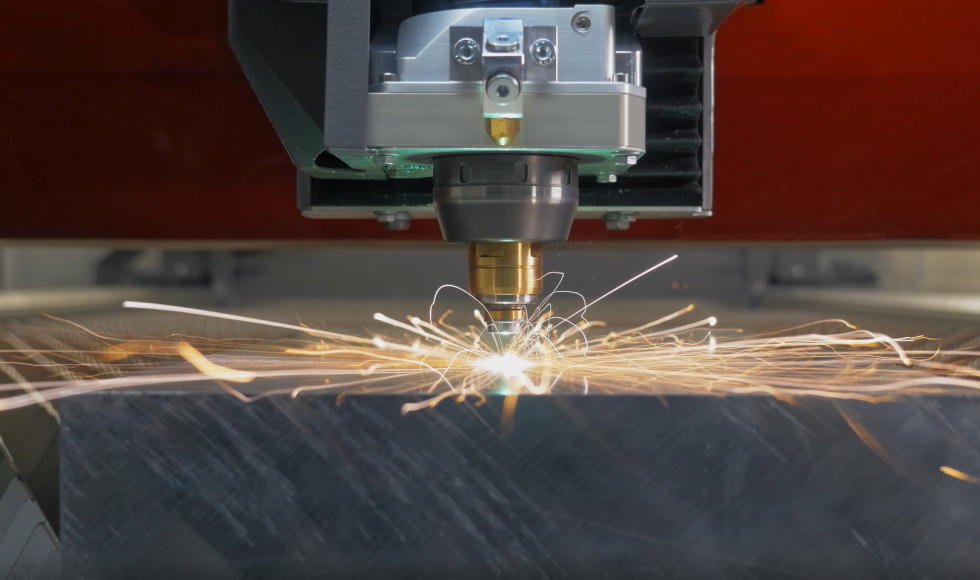CNC machine cutting metal with sparks flying